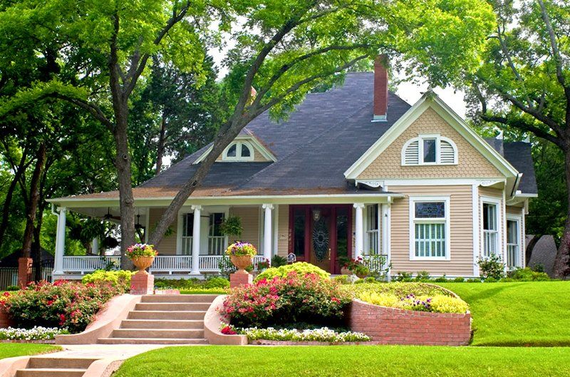 A house with a large porch and stairs leading up to it