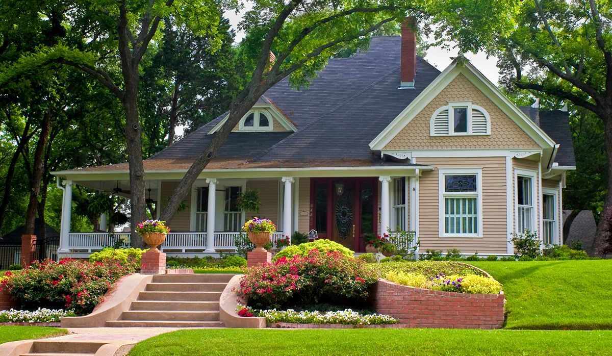 A house with a porch and stairs in front of it