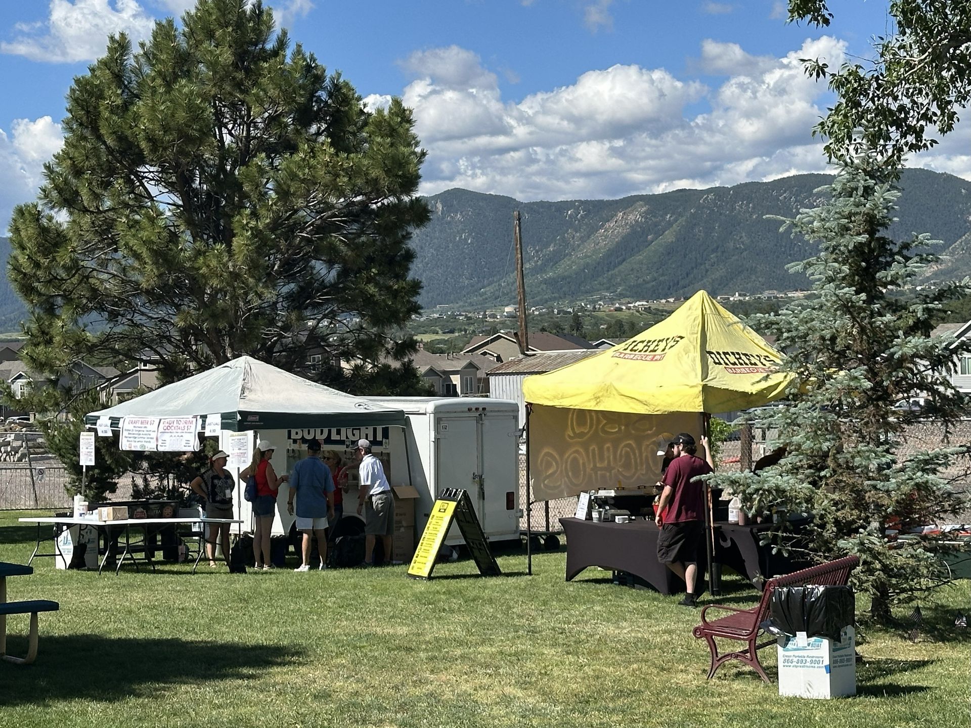 Two vendors and setting up and unloading from a trailer in anticipation before the 4th of July Beer garden opens