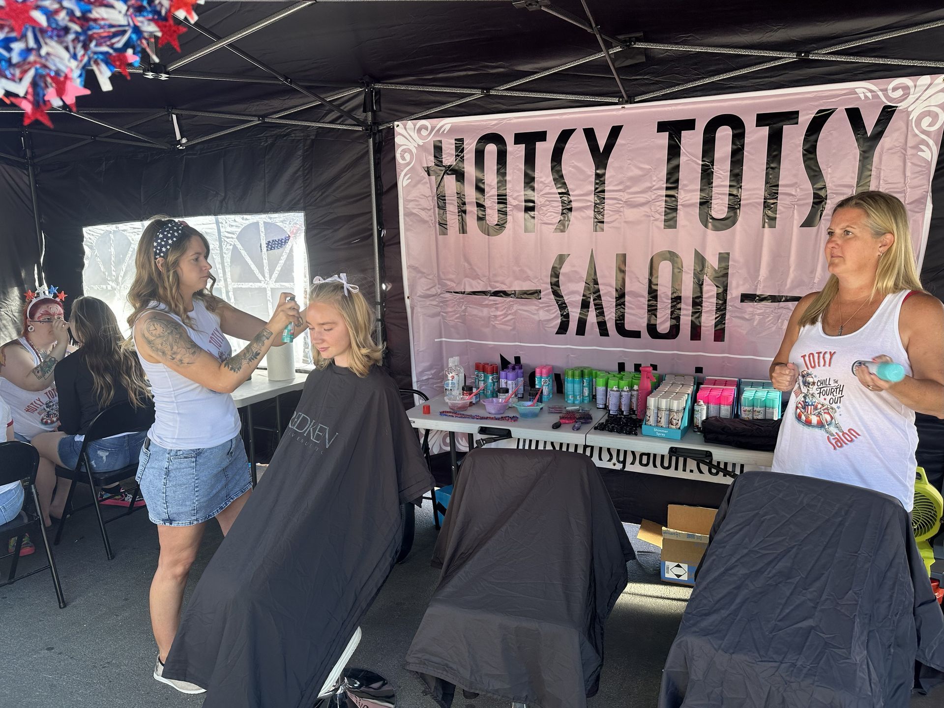 Hotsy Totsy Salon performing hair cuts and styling in-person at a booth