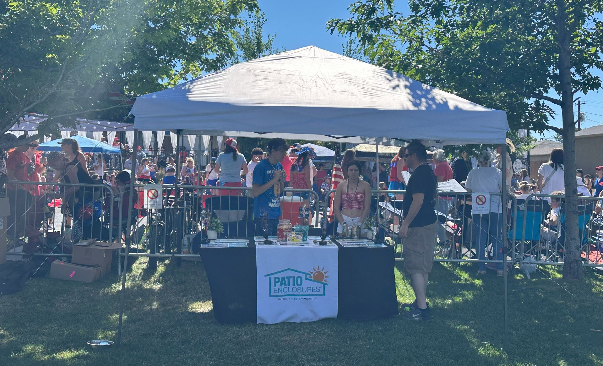The business Patio Enclosures prepares for their sponsored booth in the 4th of July Beer Gardemn before gates open