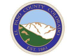 El Paso County, Colorado seal: Blue ring with text, mountain scene in center, est. 1861.
