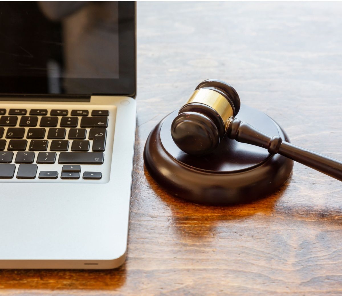 A gavel next to an open laptop.