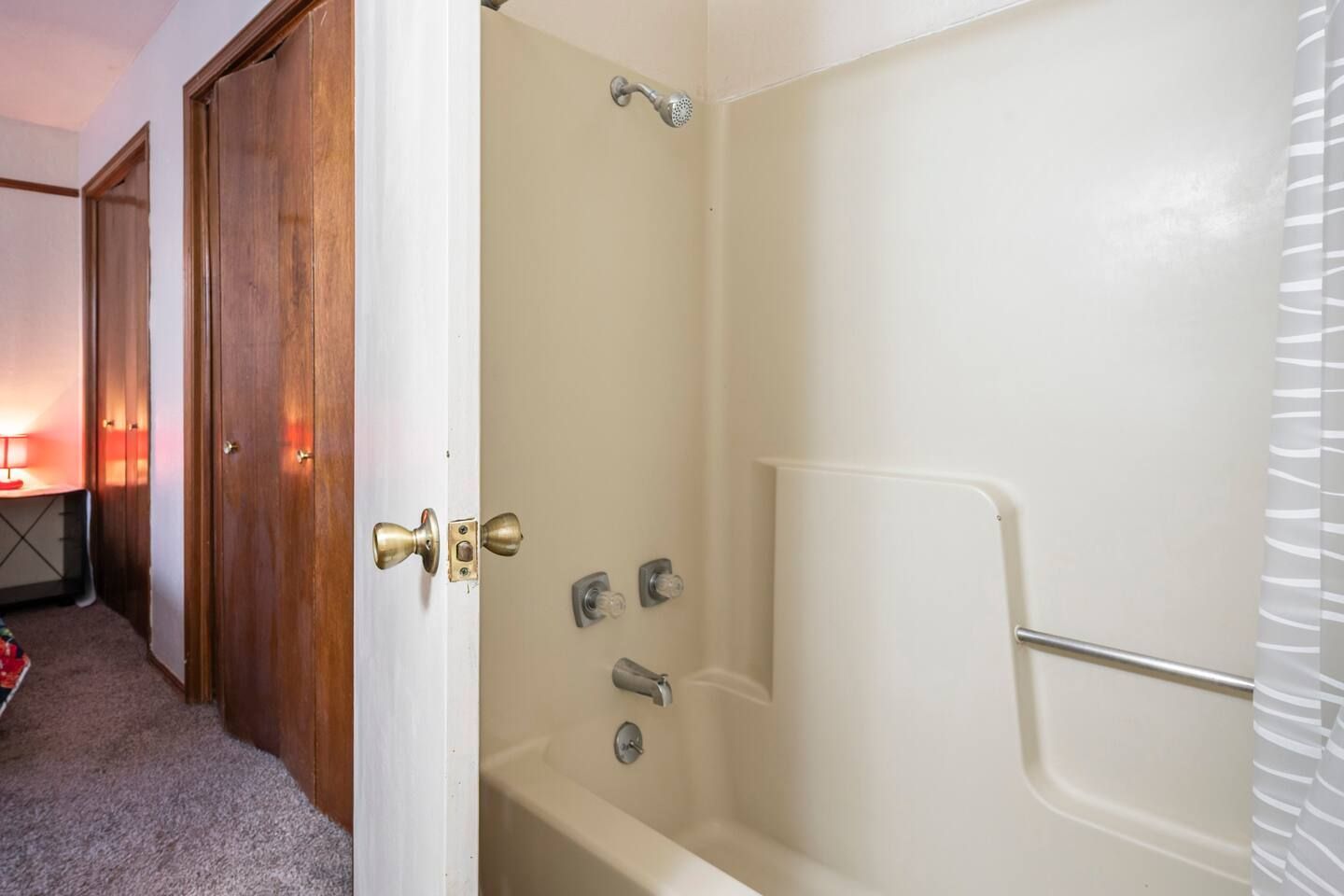 A bathroom with a bathtub and a shower.
