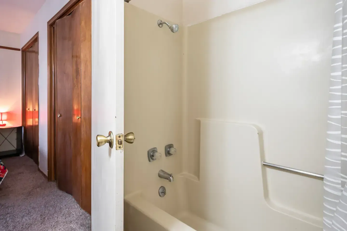 A bathroom with a bathtub and a shower.