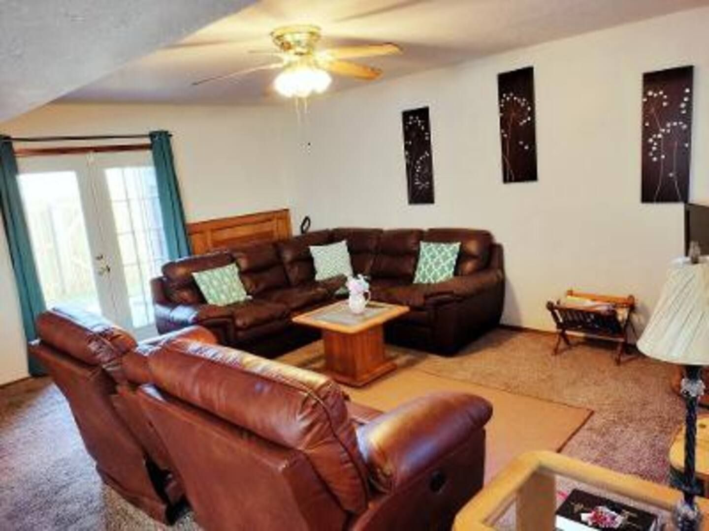 A living room filled with furniture and a ceiling fan