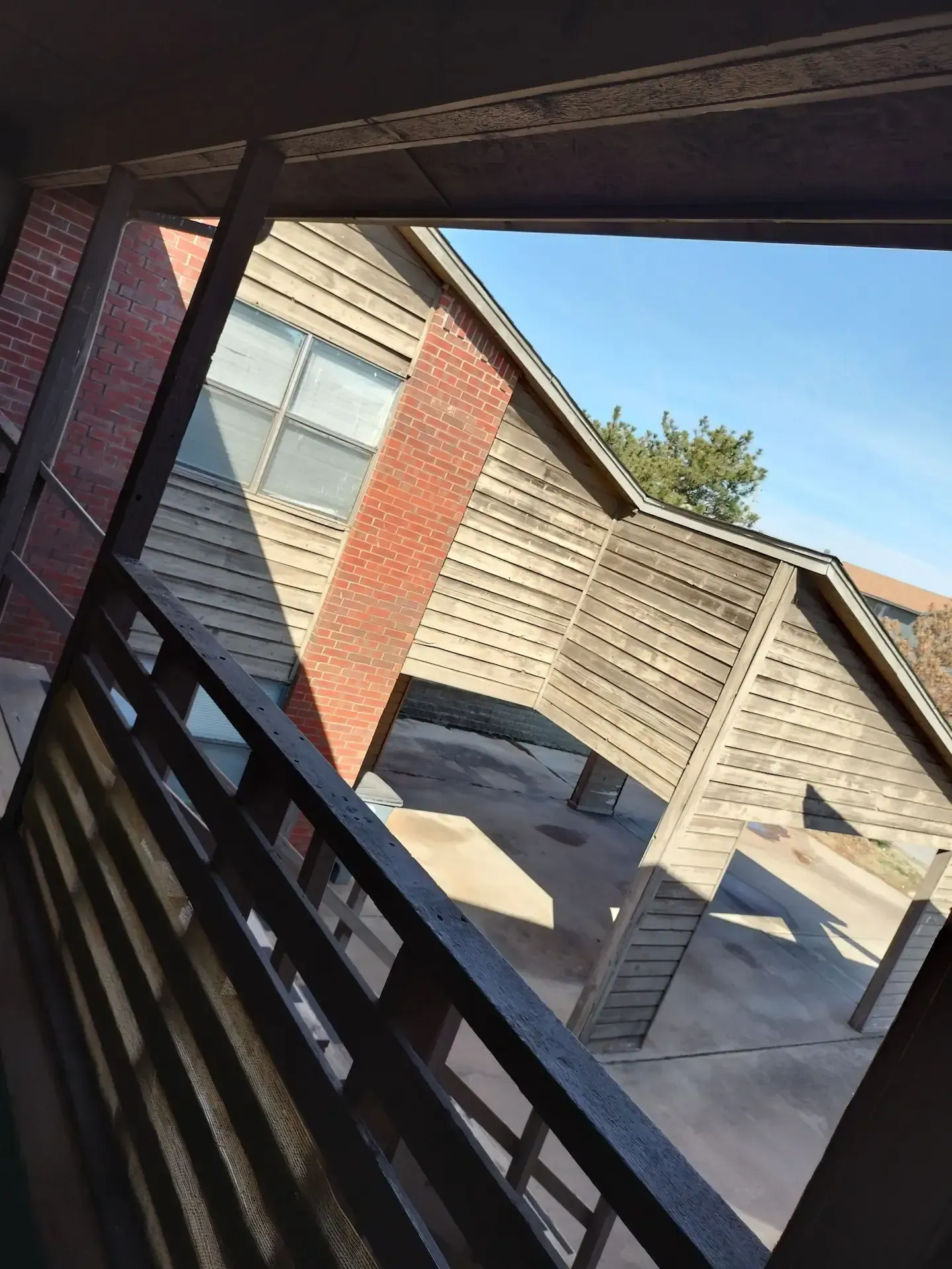 A balcony with a view of a brick building