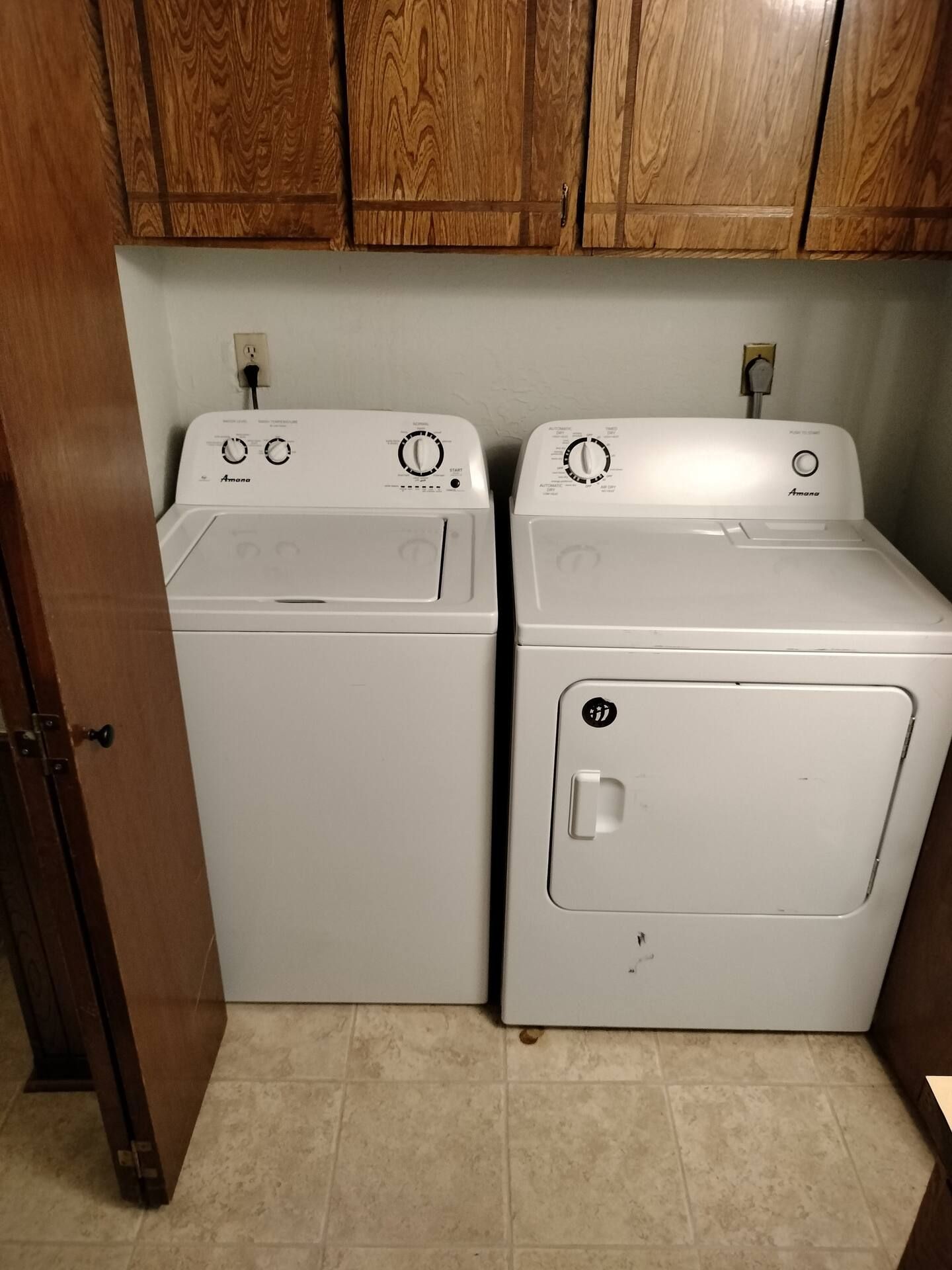 A washer and dryer are sitting next to each other in a laundry room.