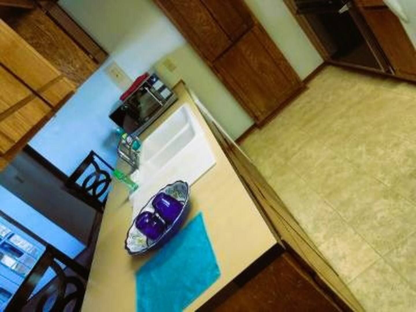 A kitchen counter with a bowl of purple cups on it
