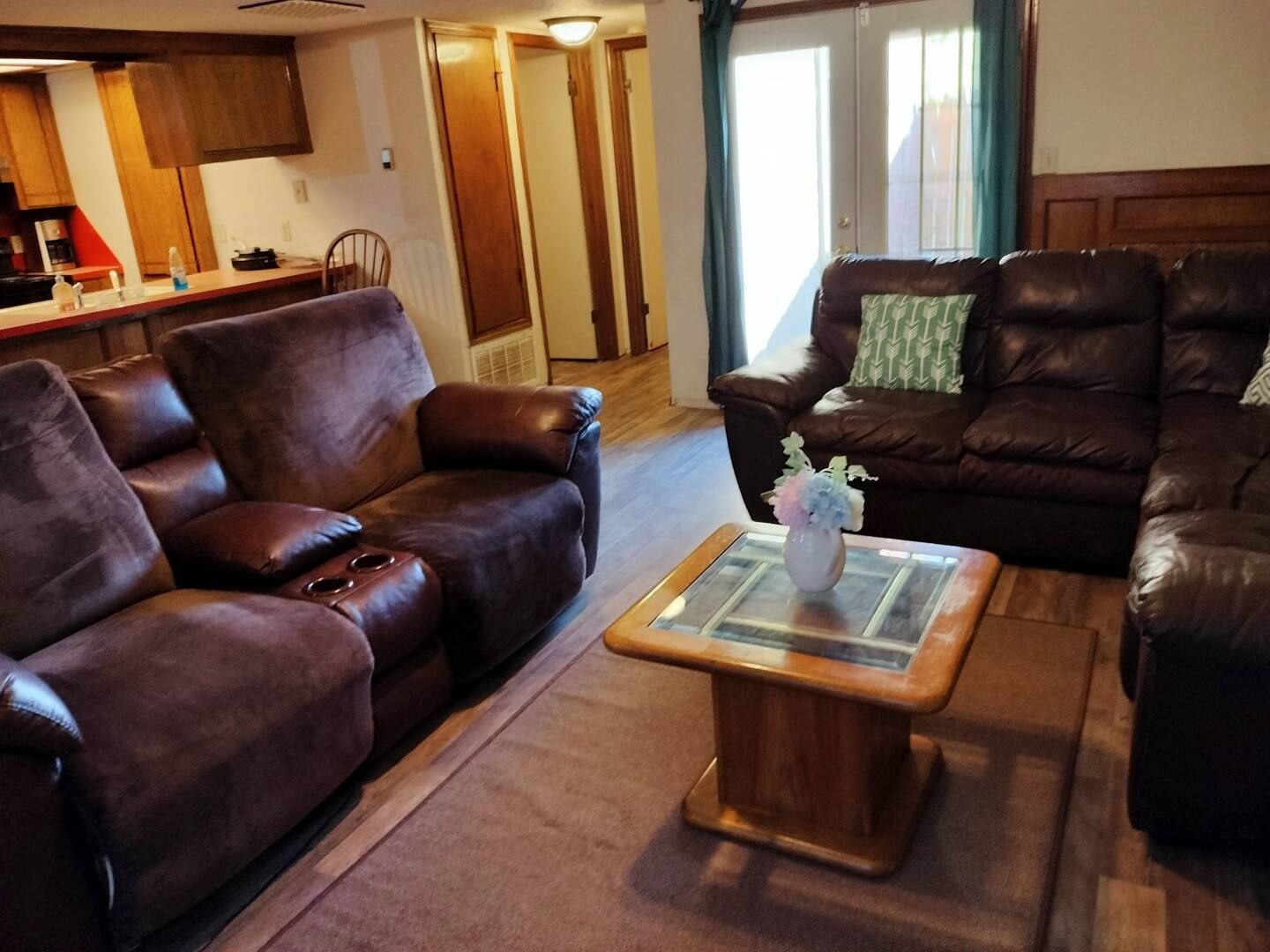 A living room with brown leather furniture and a coffee table