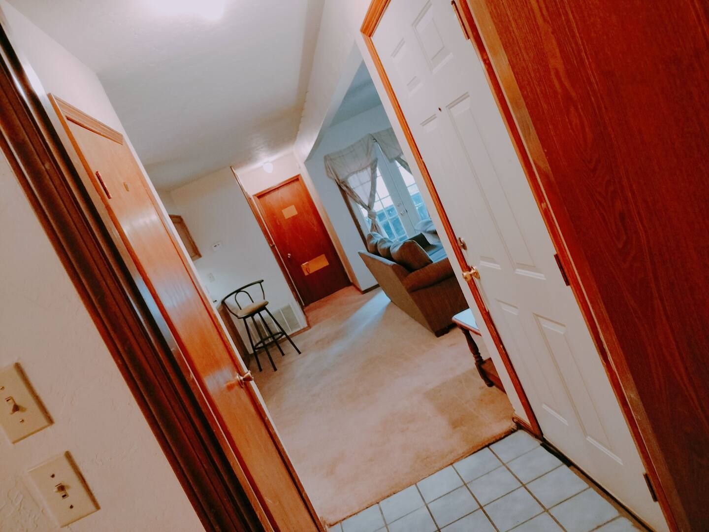 A hallway in a house leading to a living room