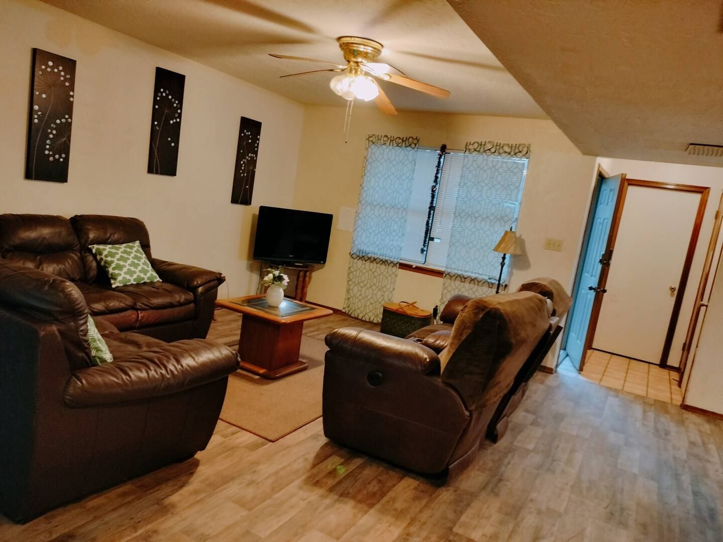 A living room filled with furniture and a ceiling fan