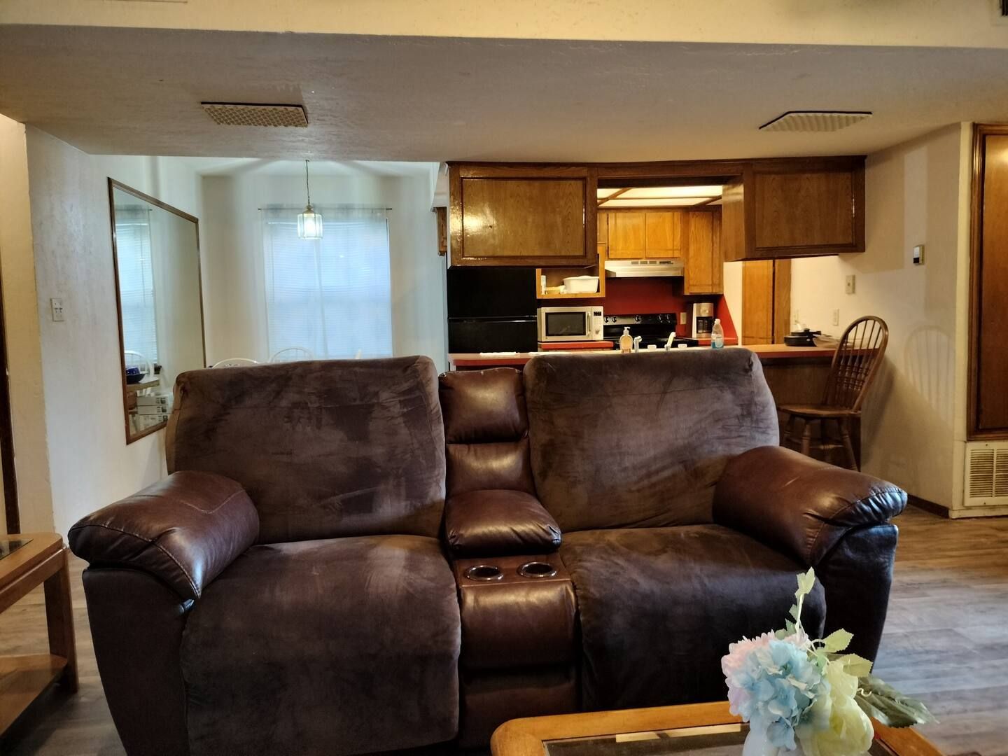 A living room with a couch and chair and a coffee table