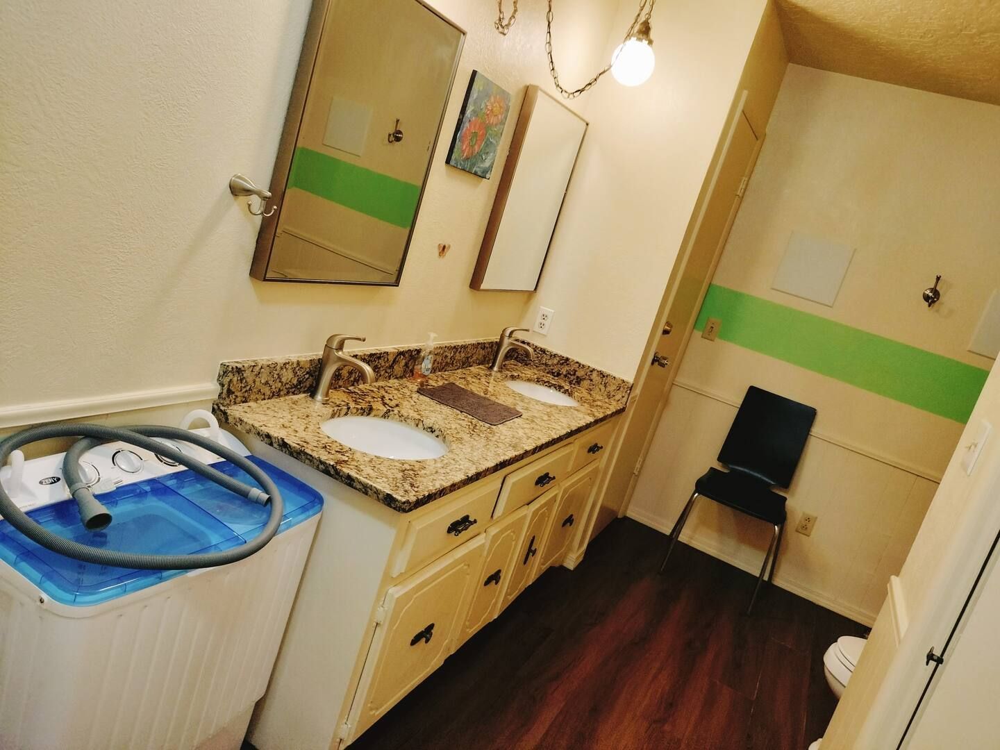 A bathroom with two sinks and a washing machine