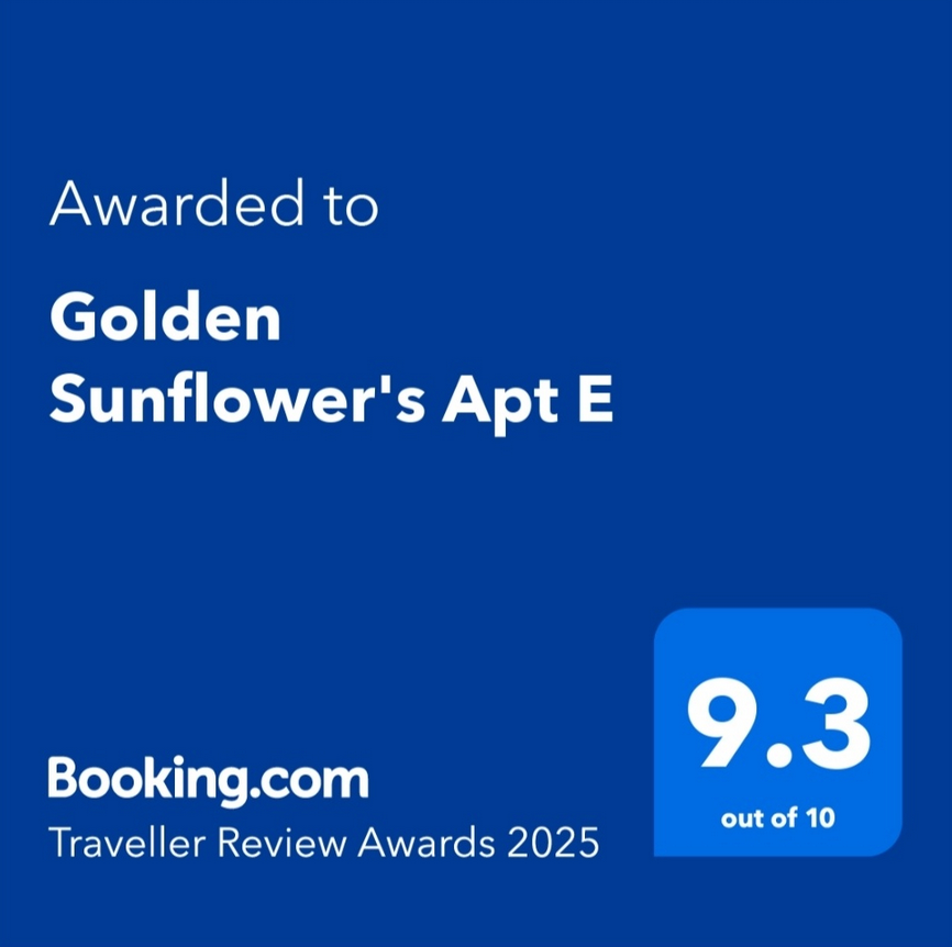 A blue sign that says ' awarded to golden sunflower 's apartment e ' on it