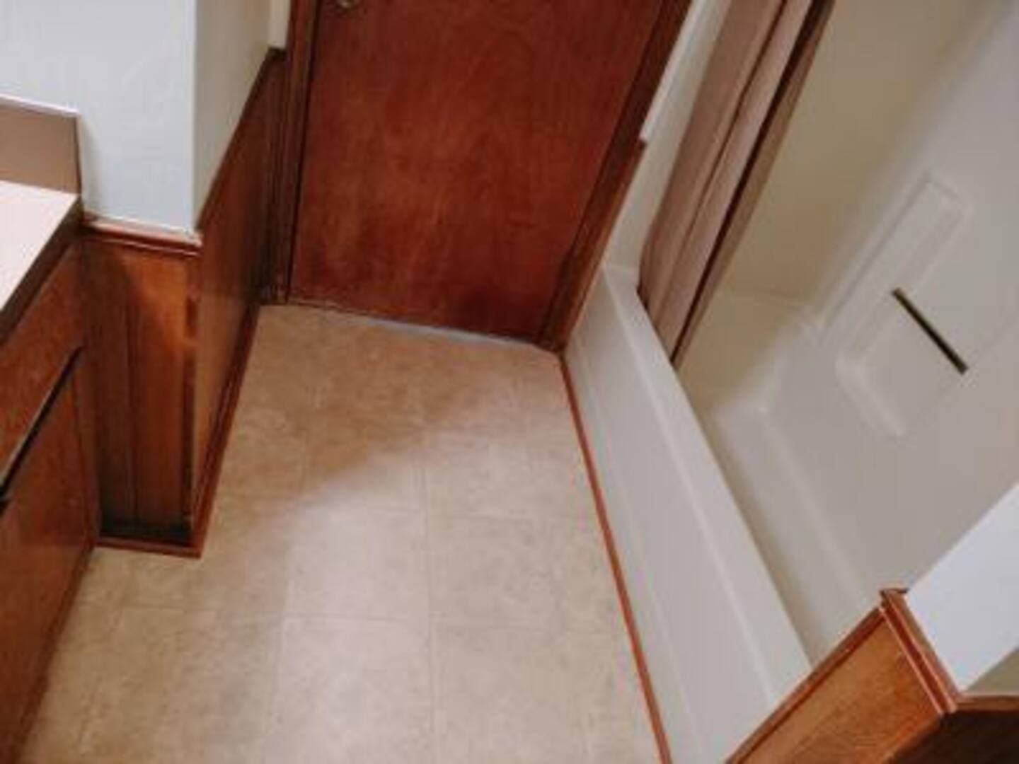 A bathroom with a bathtub and a door