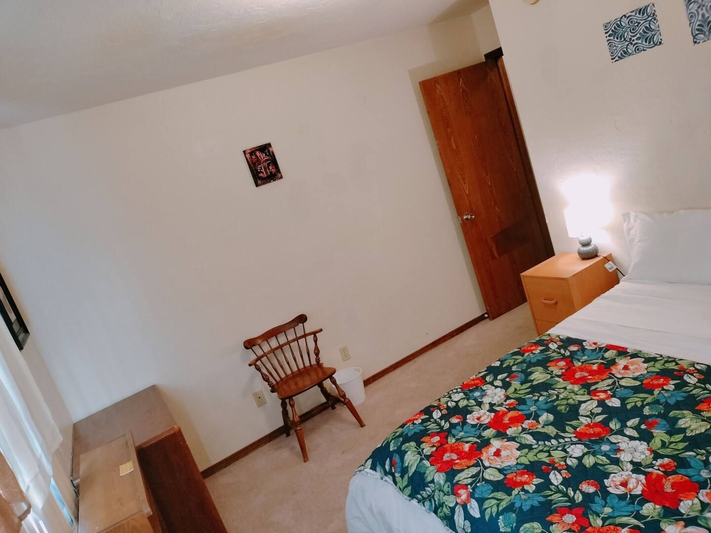 A bedroom with a bed and a chair in it