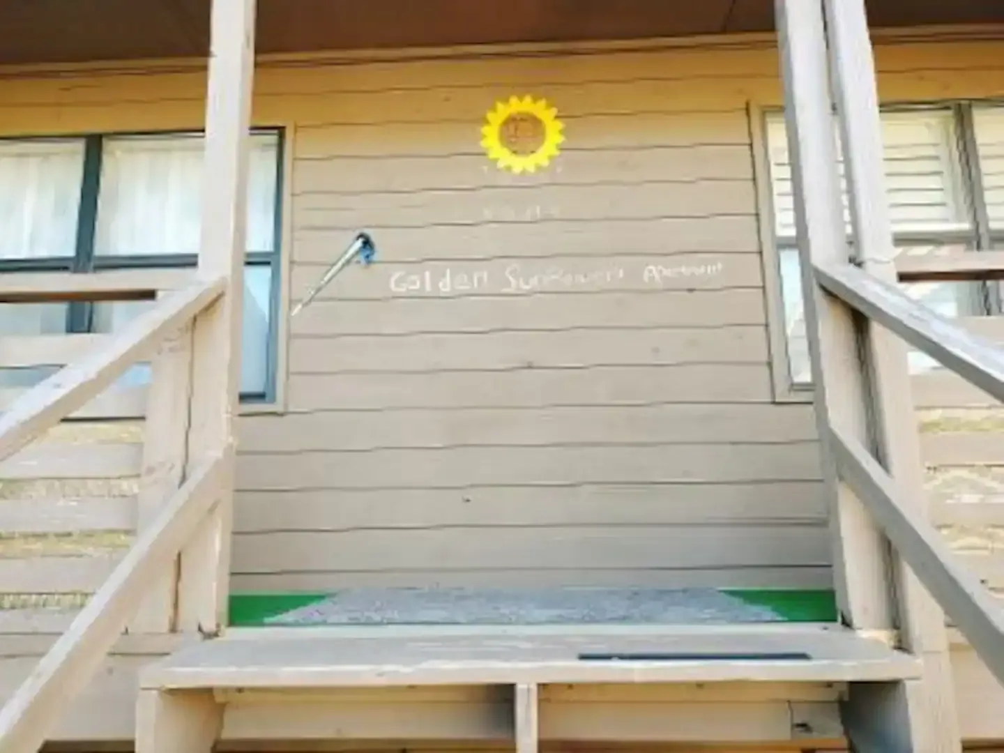 A sunflower is painted on the side of a building