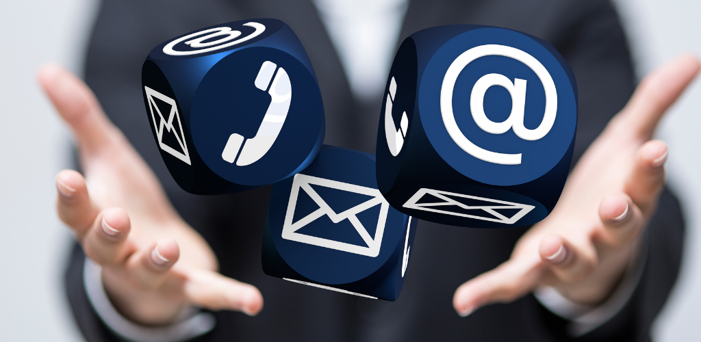 Hands holding blue cubes with email, phone, and @ contact icons