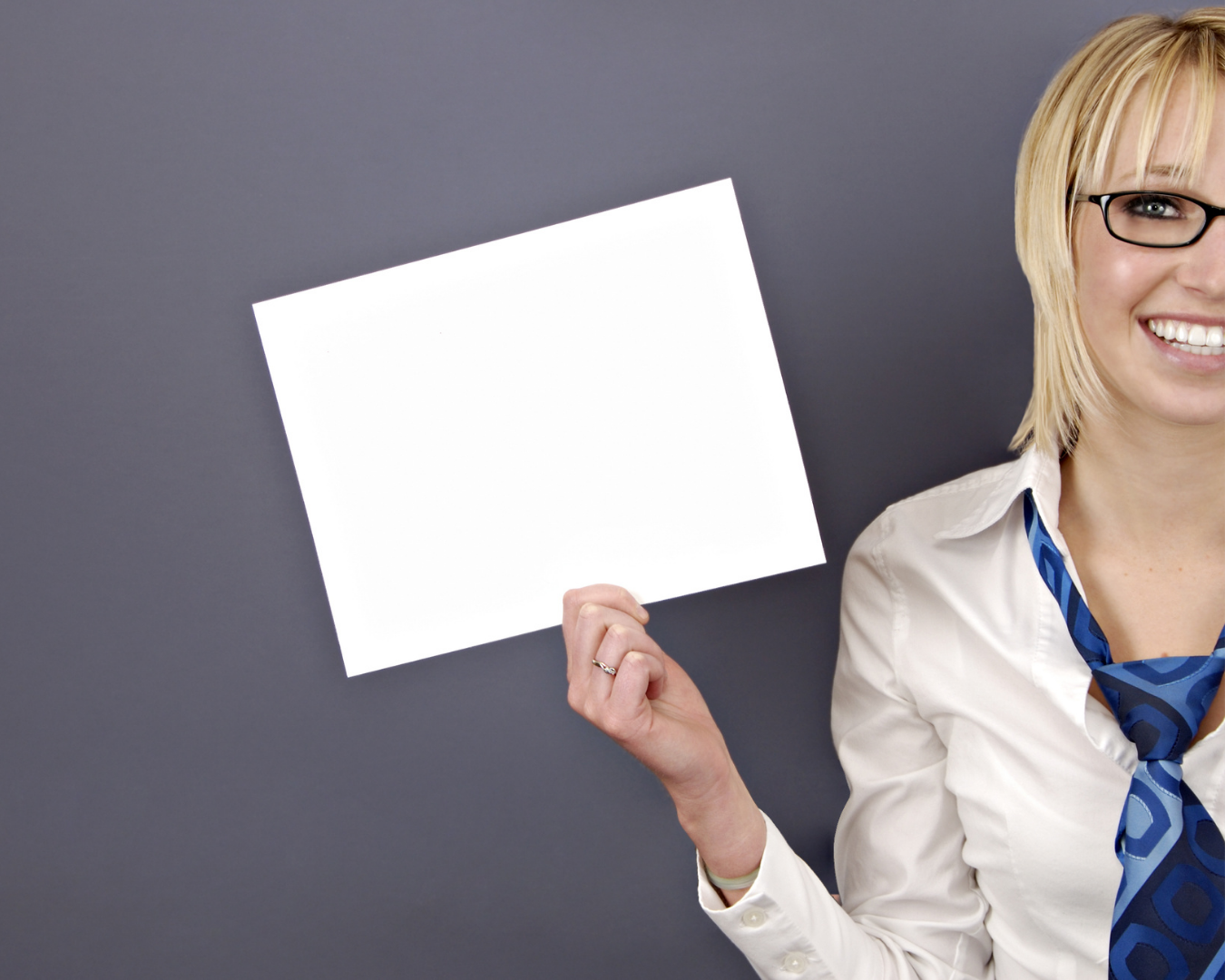 Person holding a white blank piece of paper in the air