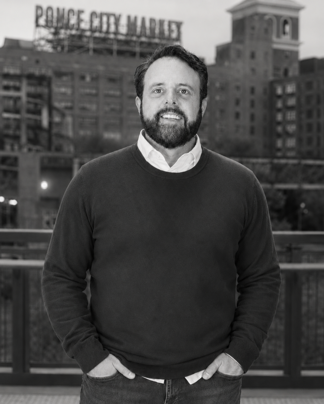 A man with a beard is wearing a black sweater