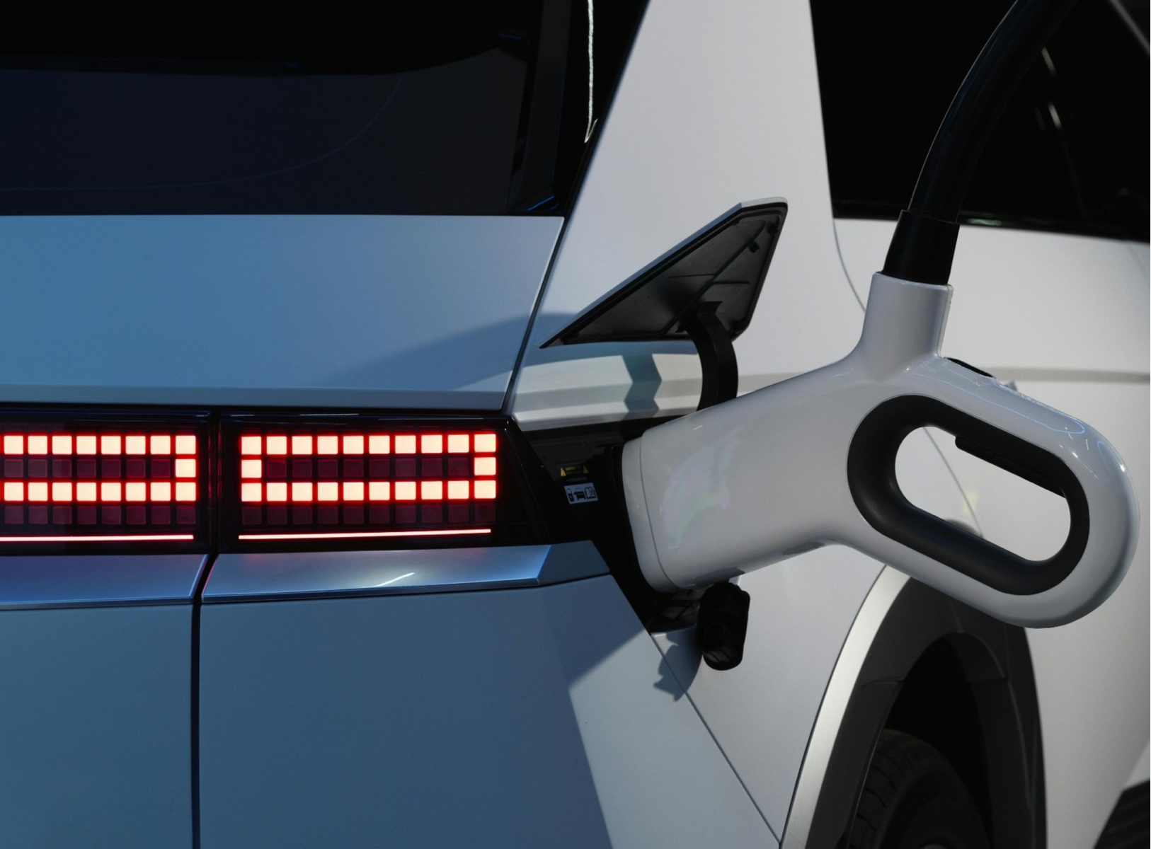A close up of an electric car being charged