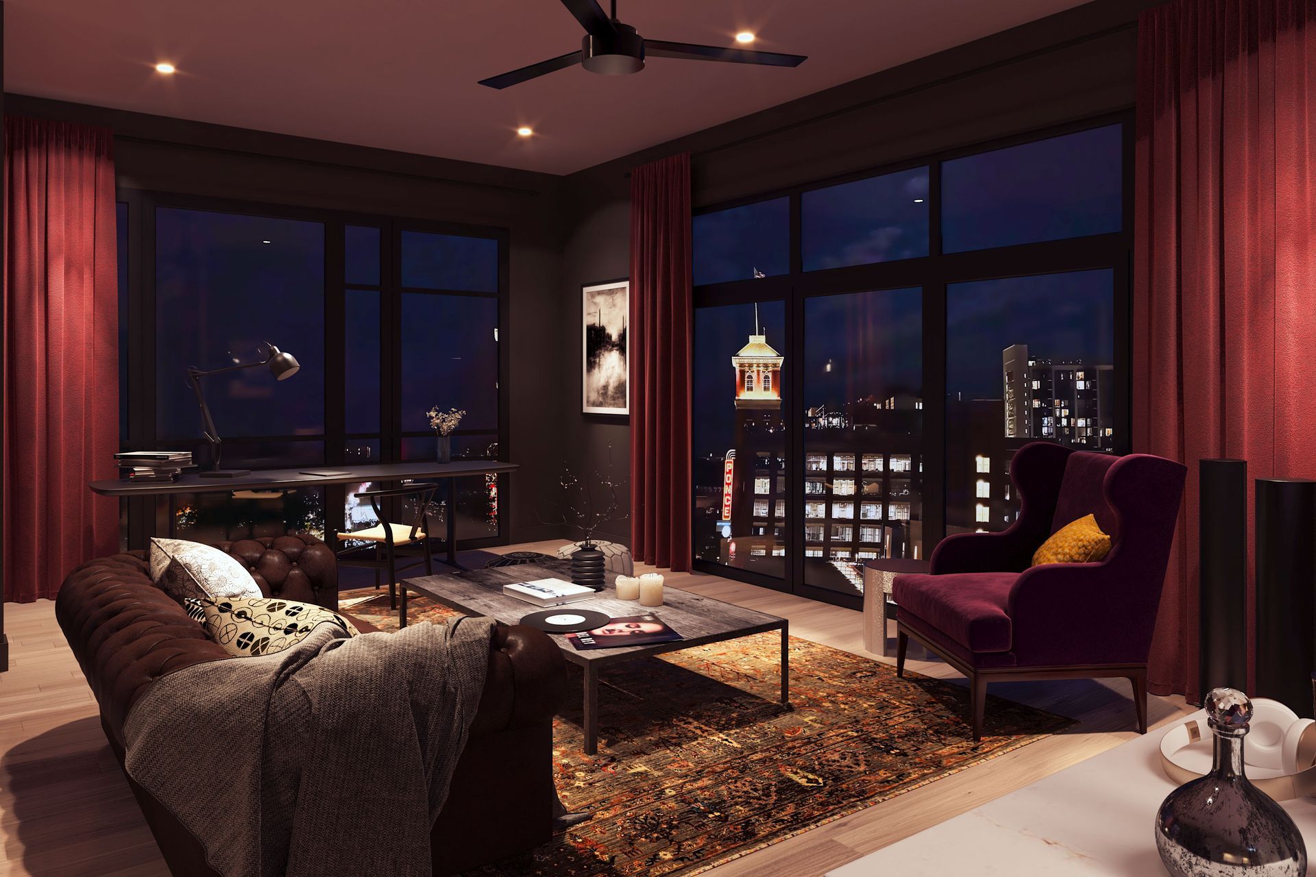 A living room with a couch , chair , coffee table and ceiling fan at night.