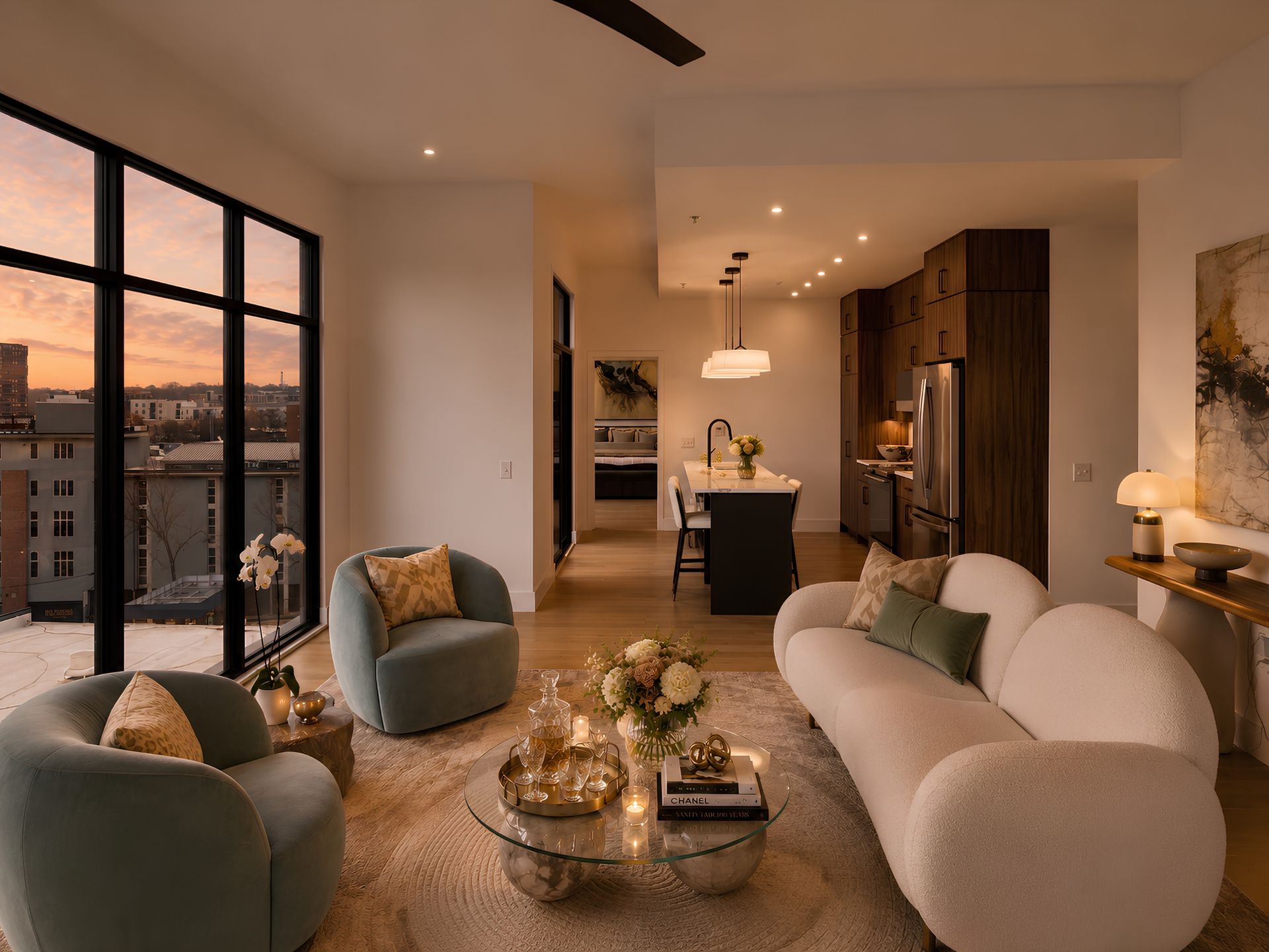 A living room with a couch , chair , coffee table and ceiling fan at night.