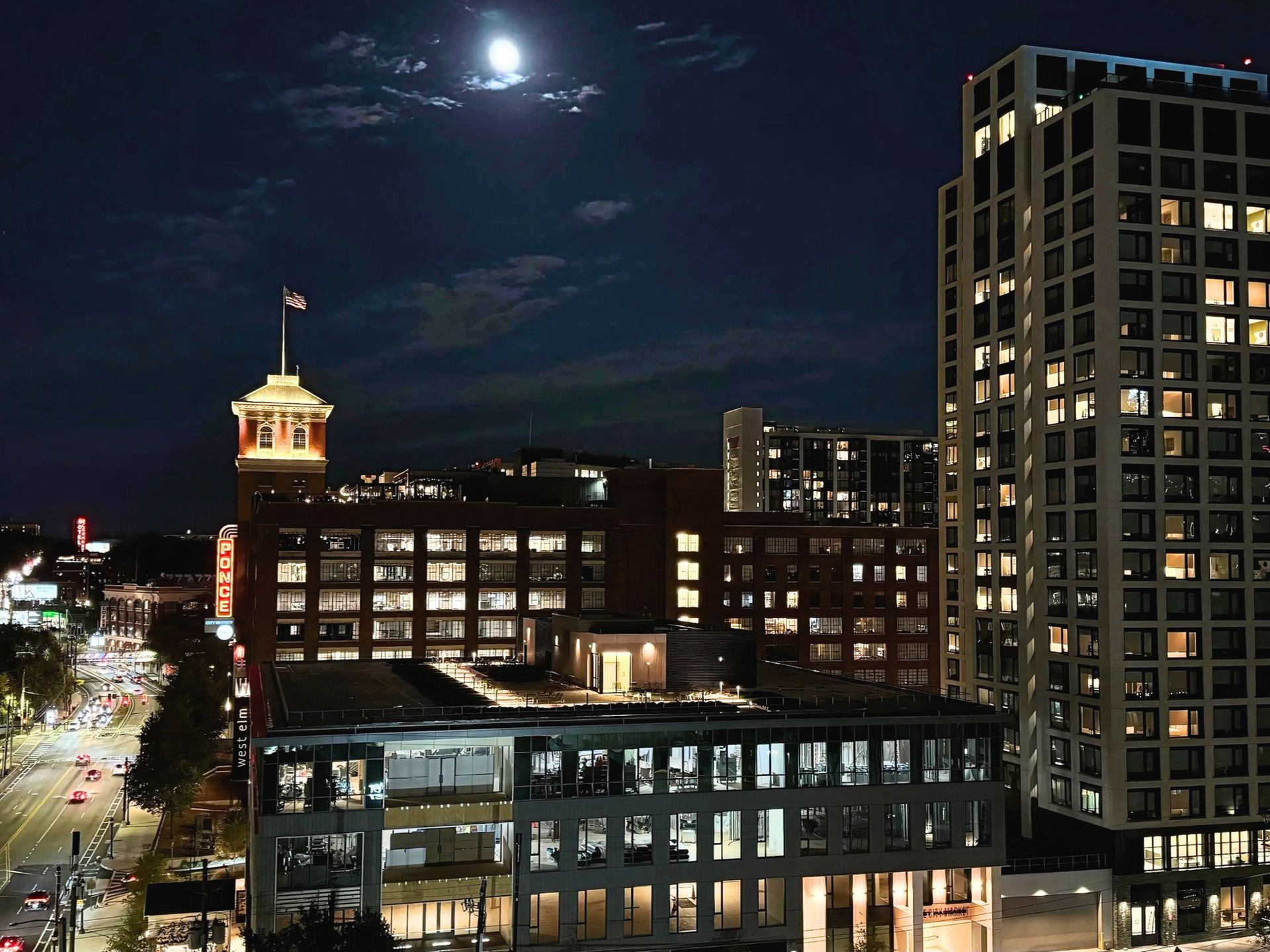 A full moon shines over a city at night