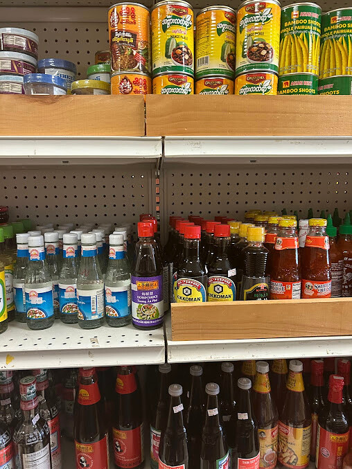 Shelves of Asian grocery products; sauces, canned goods and bottled items.