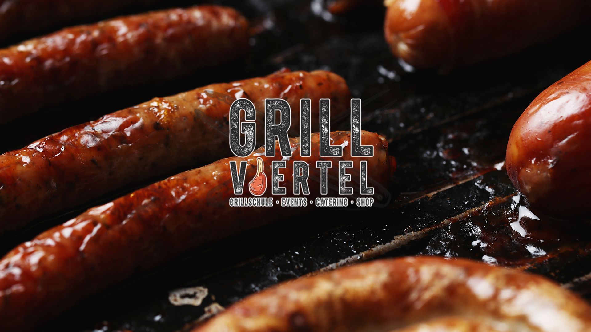 A bunch of sausages are cooking on a grill.