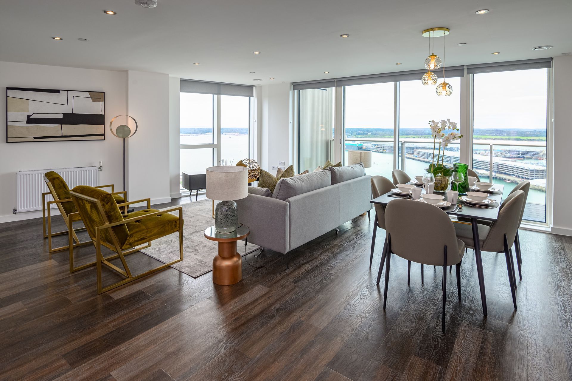 A living room with a couch , chairs , and a dining table.