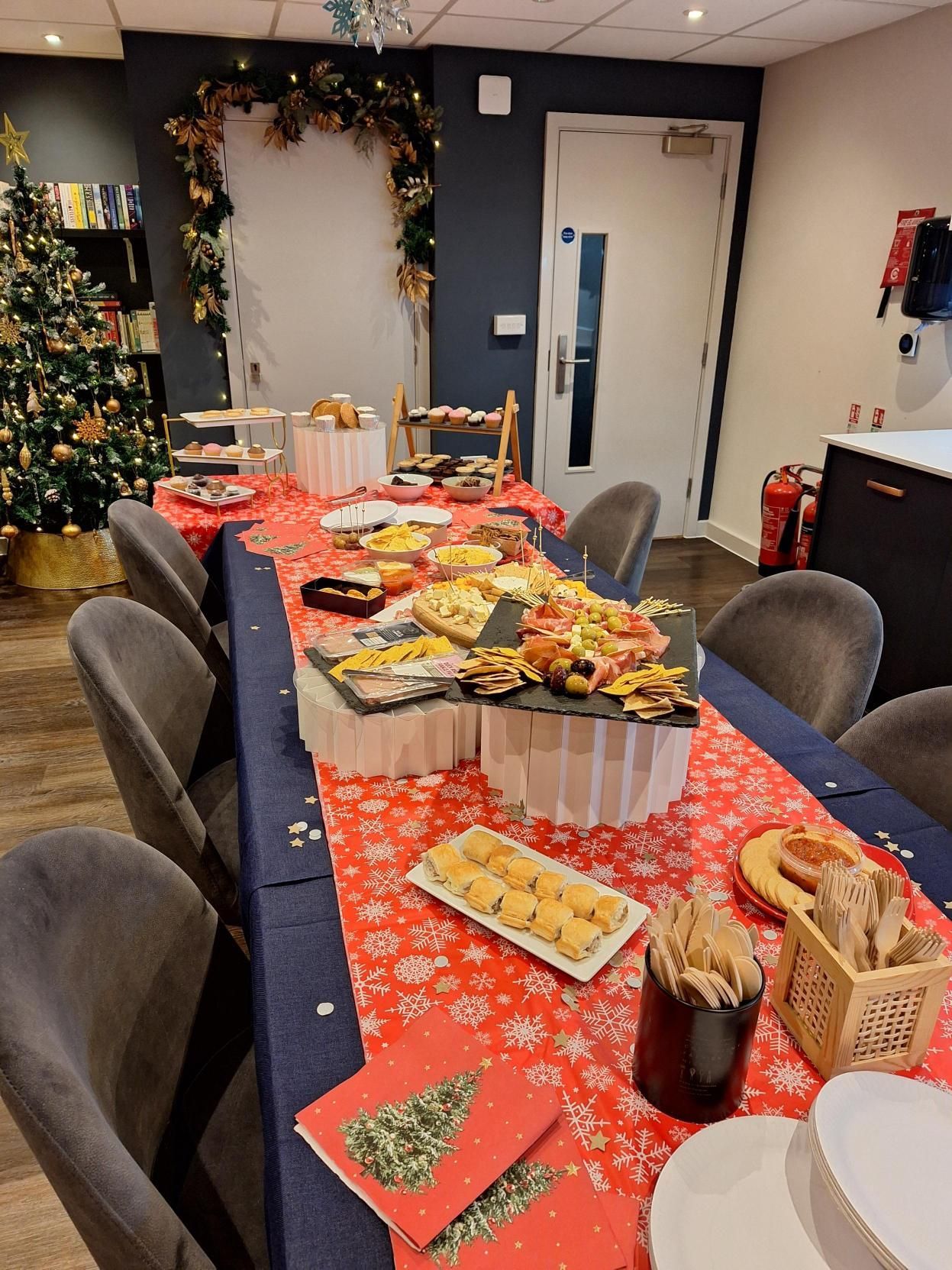 Buffet table with holiday snacks and decorations in a small conference room