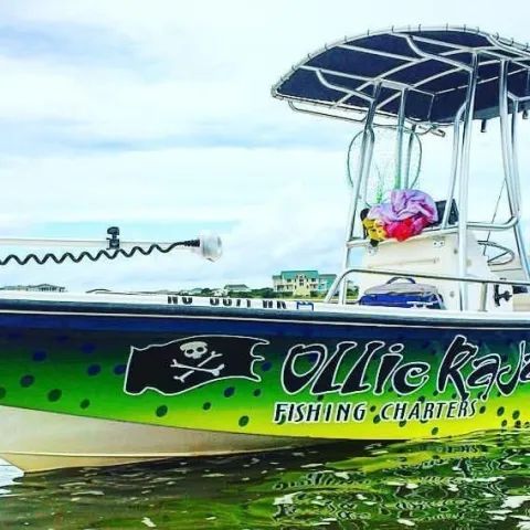 A green and yellow boat with a pirate flag logo and 