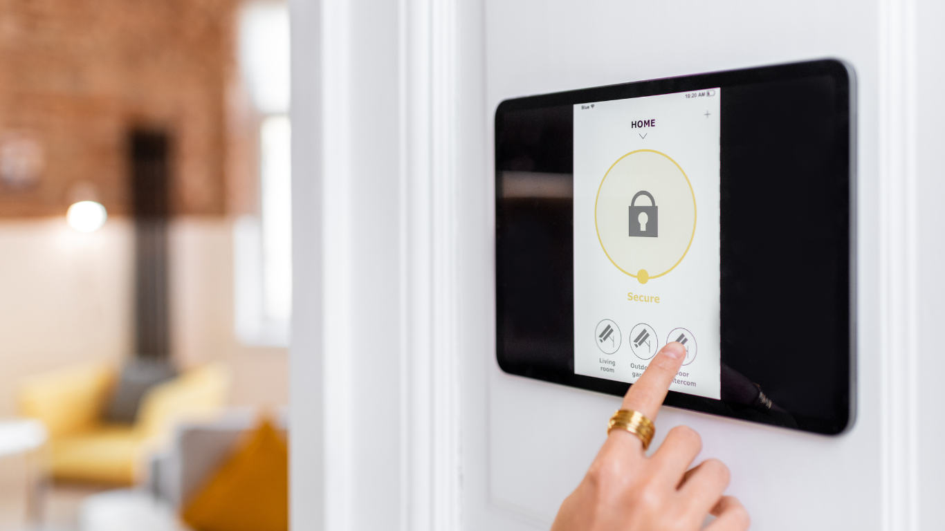 A person is pressing a button on an intercom system on a wall.