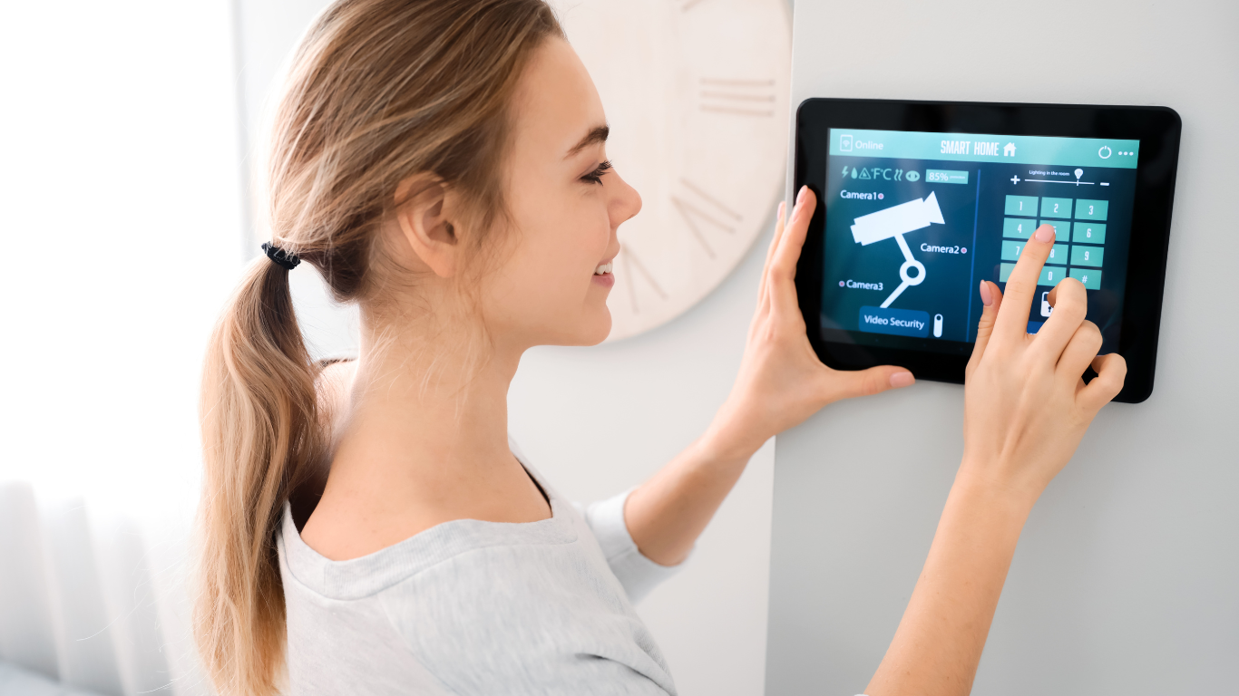 A woman is using a tablet to control an access control system.
