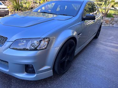 Silver Sedan Parked Outdoors On A Driveway, Front-left View, With Black Wheels — Car Detailing Mobile Cleaning Co In Port Macquarie, NSW