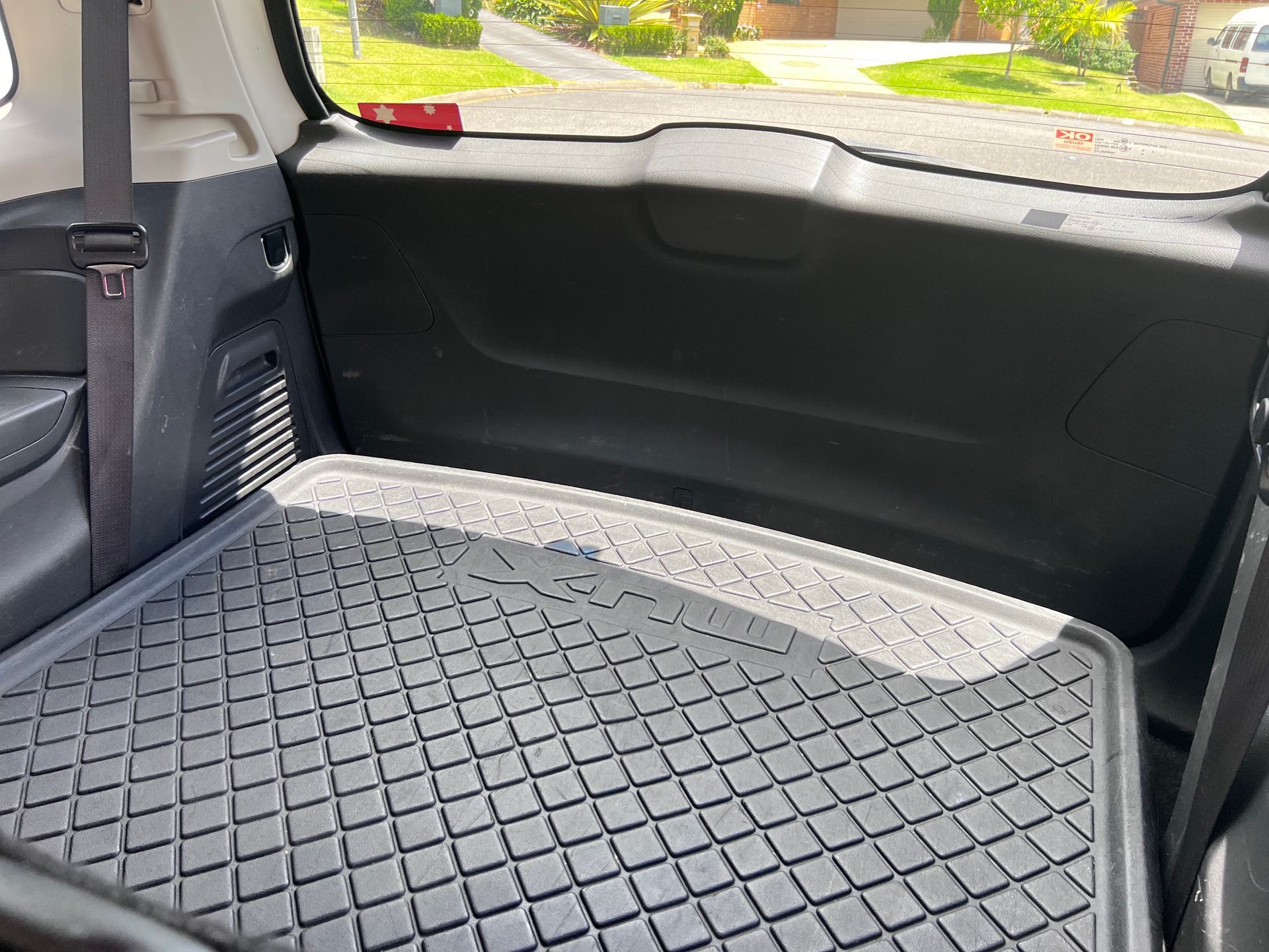 Folded Rear Car Seat With Black Diamond-pattern Cargo Mat — Car Detailing Mobile Cleaning Co In Port Macquarie, NSW