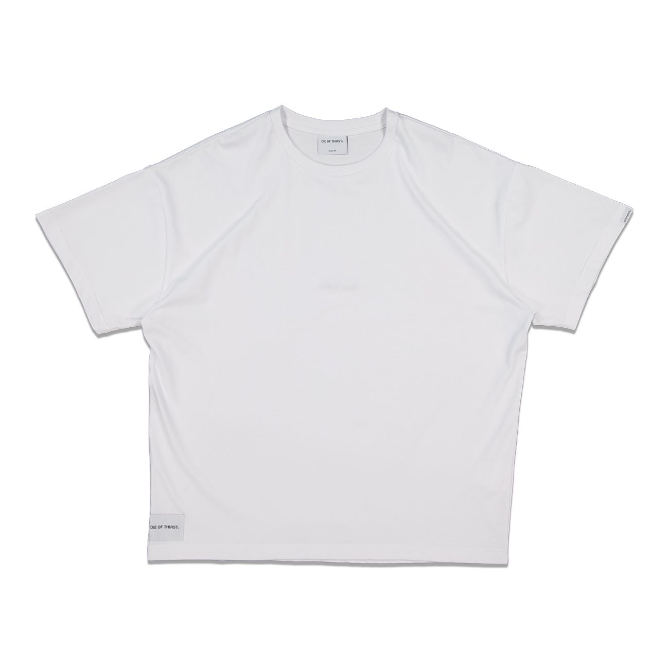 White oversized t-shirt with short sleeves; small logo on the chest and tag on the bottom left.