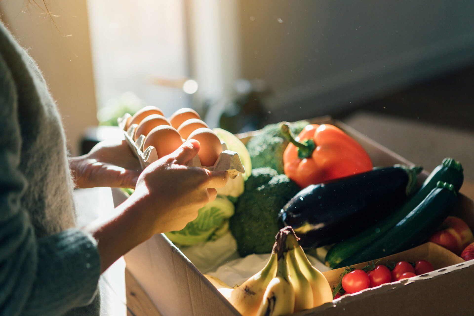 Woman with a Box of Fruits and Vegetables — Orange, CT — New England Dental Health Services PC