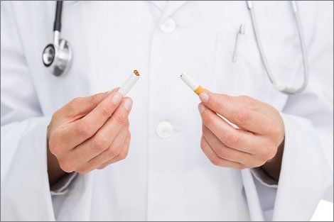 Doctor Holding a Broken Cigarette — Orange, CT — New England Dental Health Services PC Doctor Holding a Broken Cigarette — Orange, CT — New England Dental Health Services PC