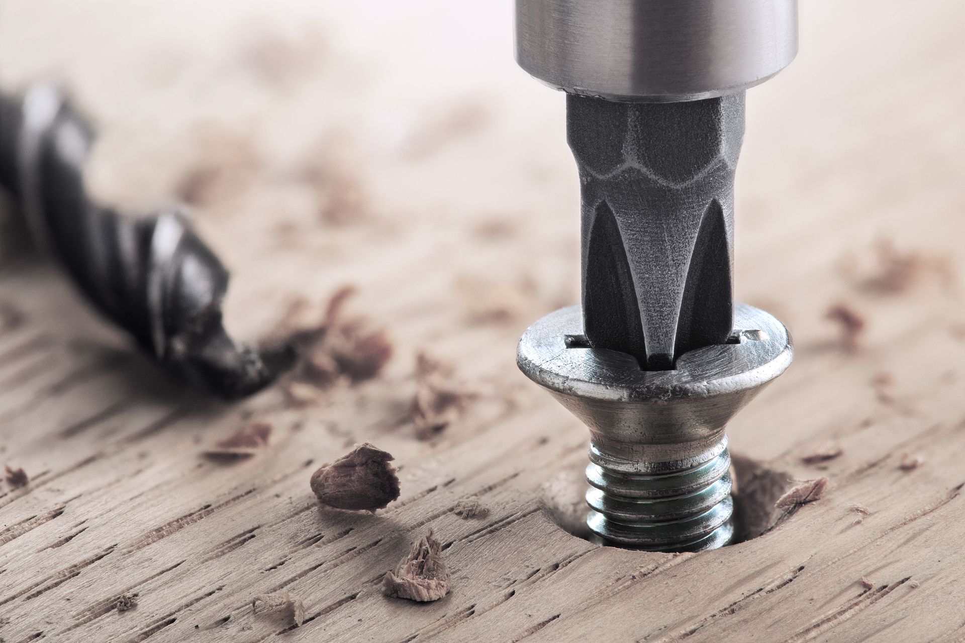 A screw is being drilled into a piece of wood.