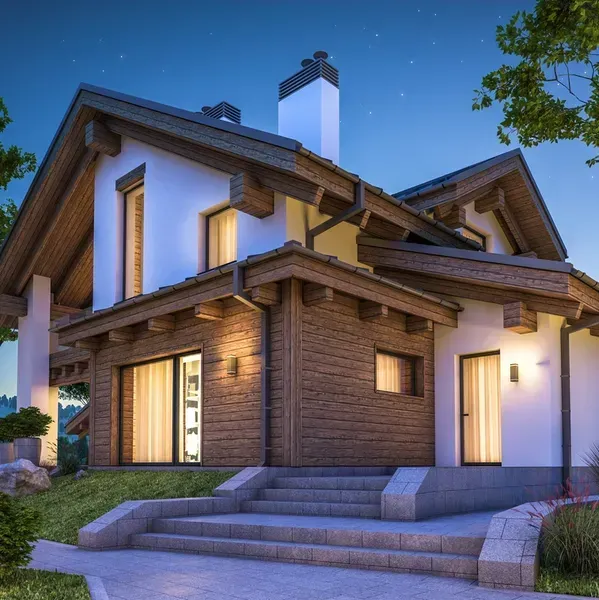 A large house with stairs leading up to it is lit up at night.