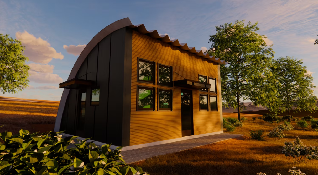 Small modern cabin with dark curved roof and large windows in a sunny rural landscape.