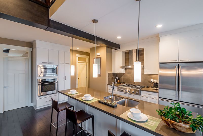 a kitchen with stainless steel appliances and white cabinets