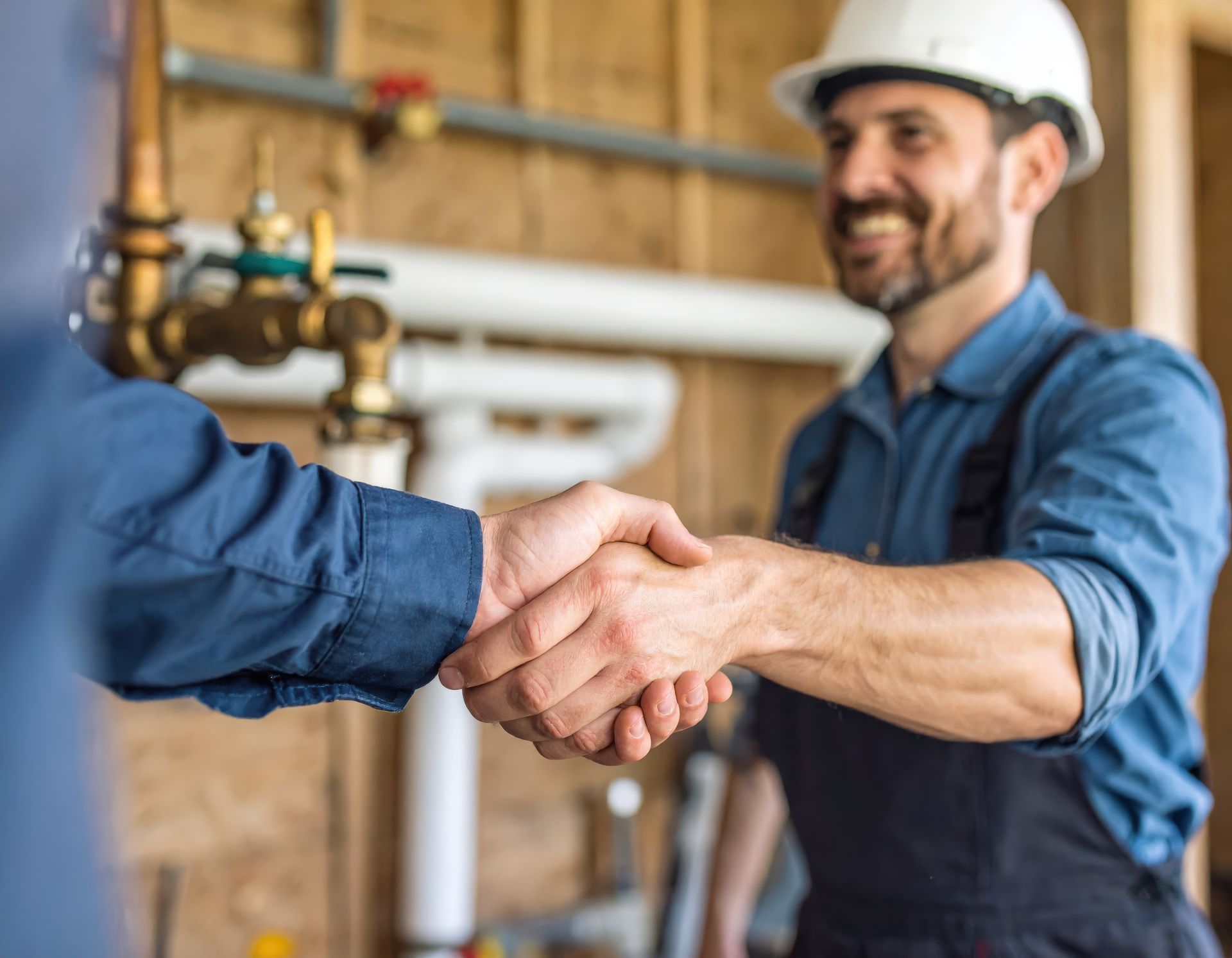 Atlantic Green plumbing contractor shaking hands with a Fredericksburg homeowner after completing a residential plumbing repair.