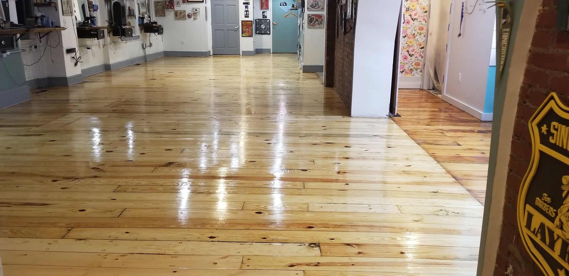 A room with a wooden floor and a sign that says ' sn ' on it