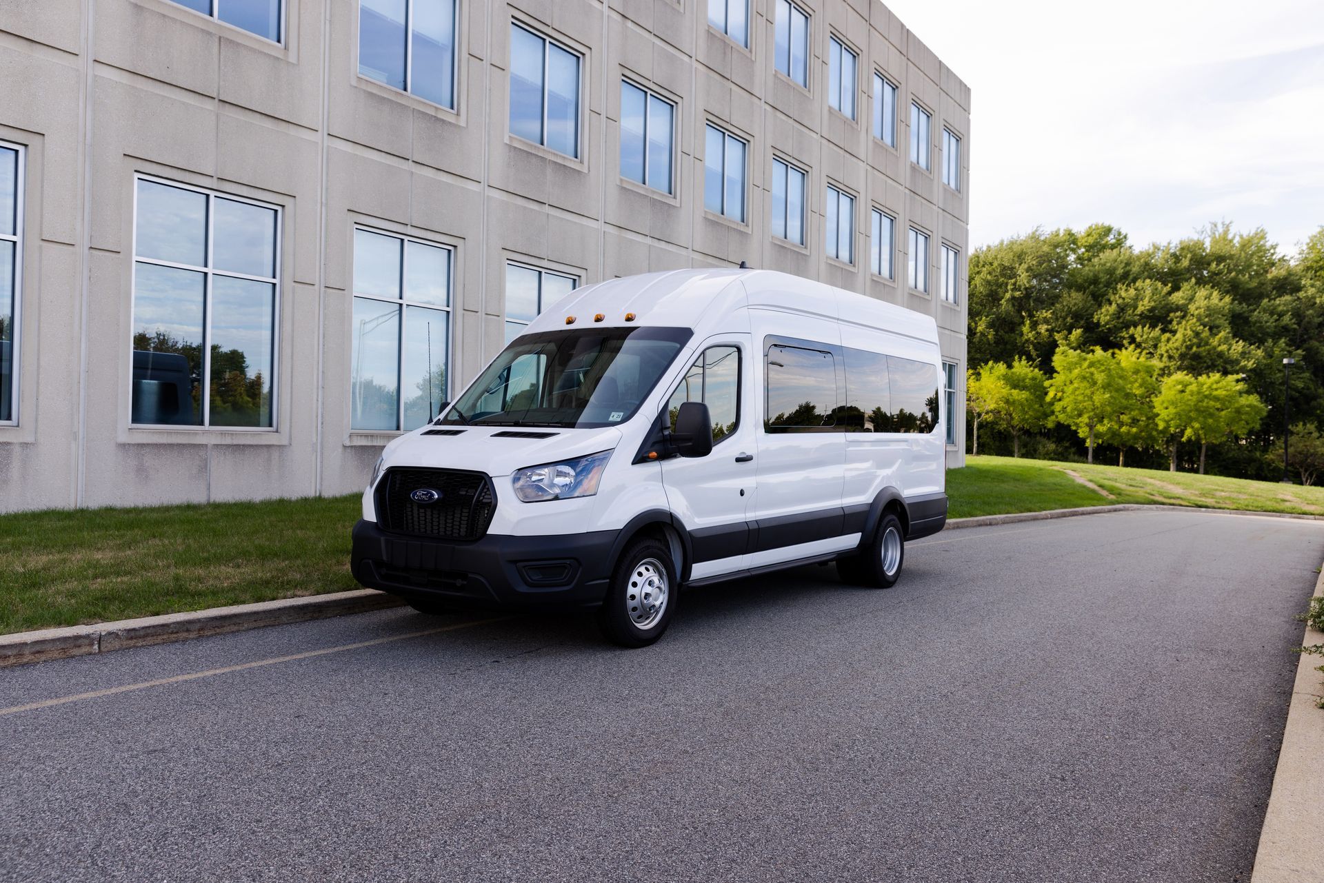 A white van is parked in front of a building.