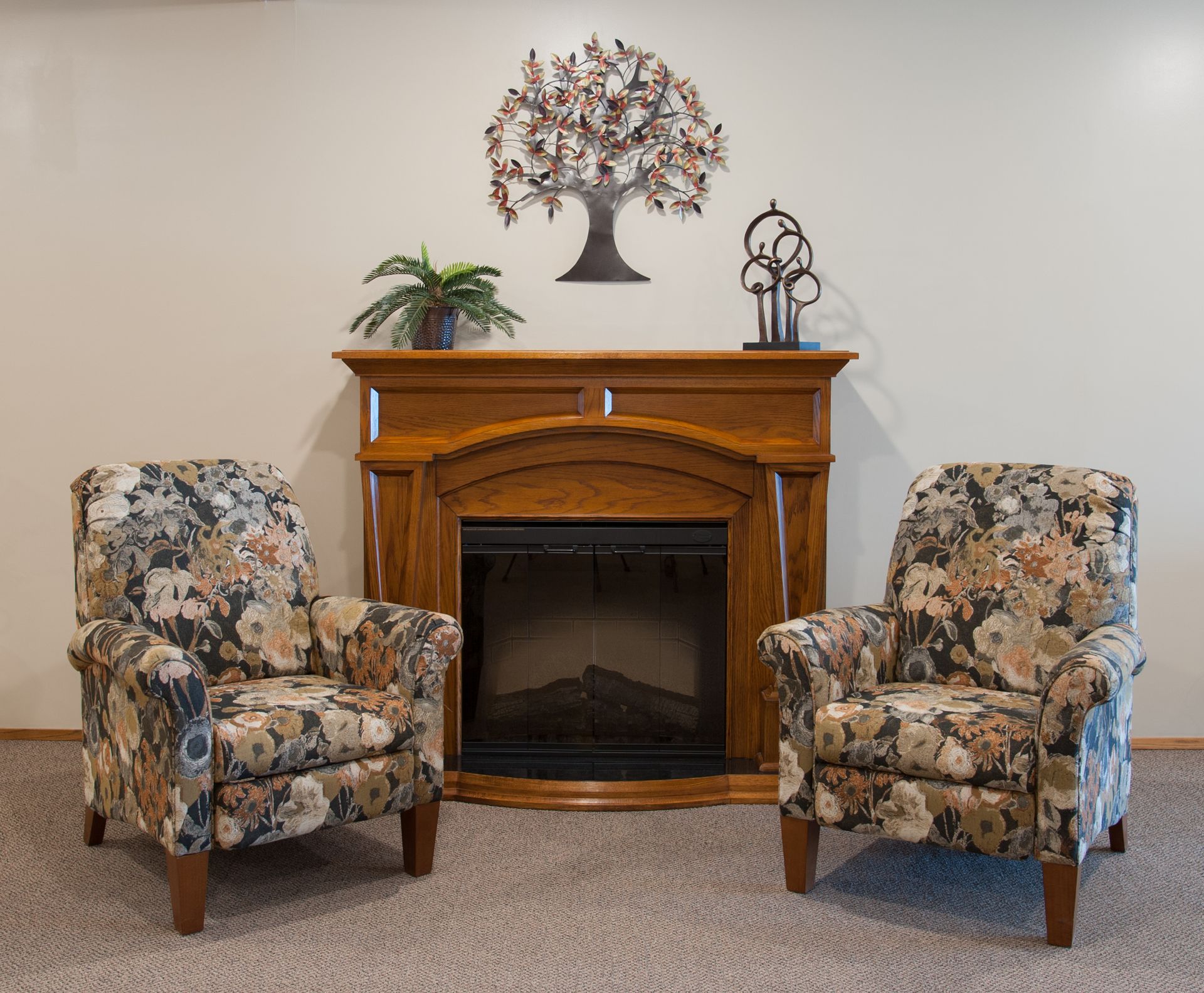 a fireplace with two chairs in front of it