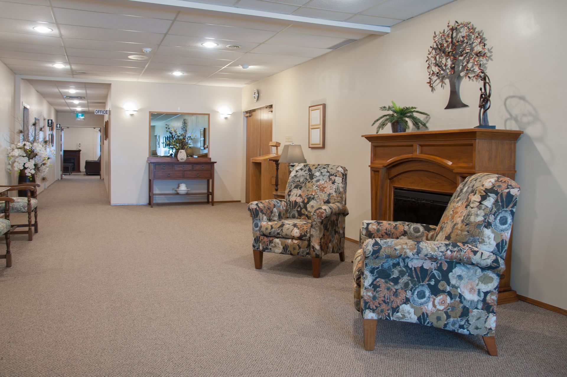 a hallway with two chairs and a fireplace and a sign that says exit